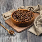 Ground coffee and coffee beans in the wood bowls